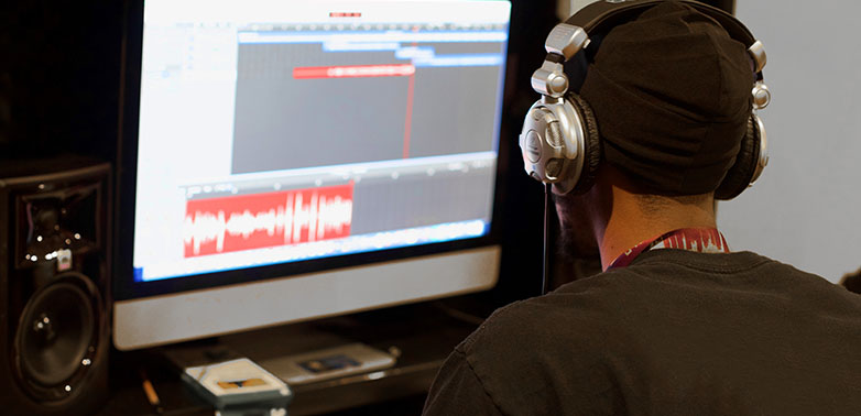 A student in SchoolTalk's Music Production & Career Development Program produces a song in our digital studio.