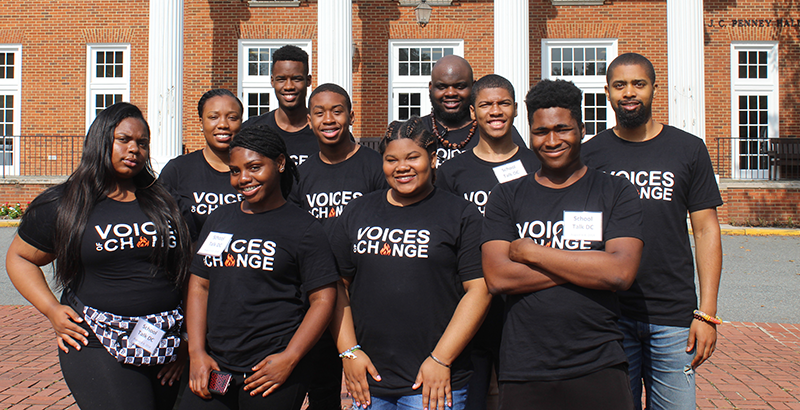 A group of SchoolTalk youth and staff pose for a photo on a D.C. college campus.